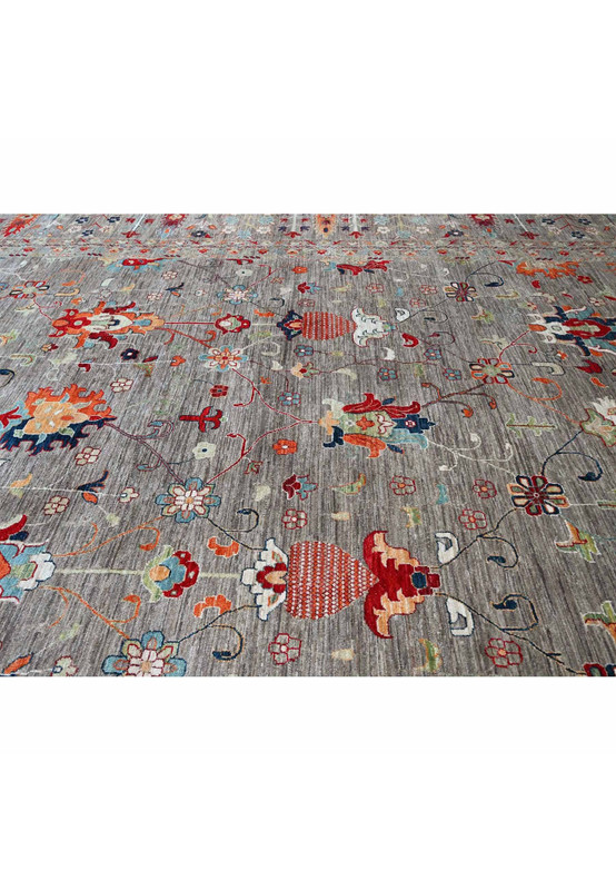 Plush wool pile close-up showing colorful floral motifs and fine detail against the grey Sultani field