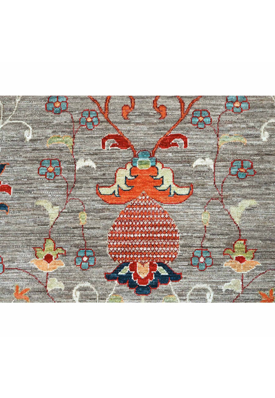 Detail of a rust pomegranate palmette with teal blossoms and navy leaves on the grey ground