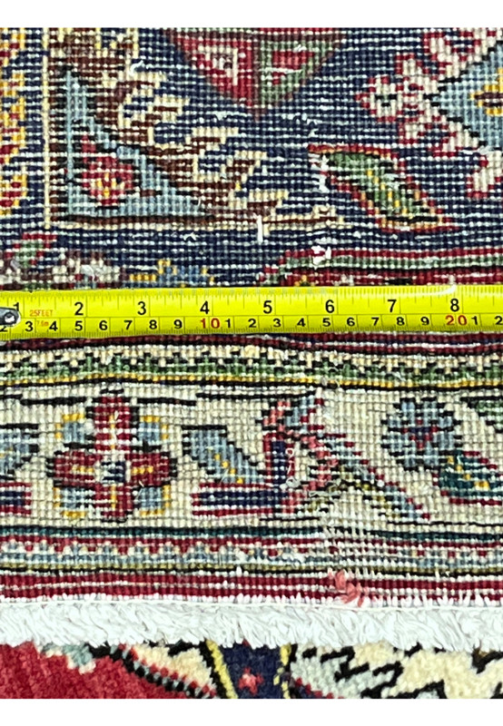 Backside knot count meassured with tape, showing 160 to 180 KPSI density on cotton foundation