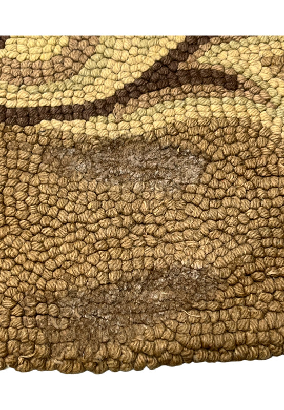 Low pile area showing gentle wear down to the foundation, shown honestly on this hooked rug