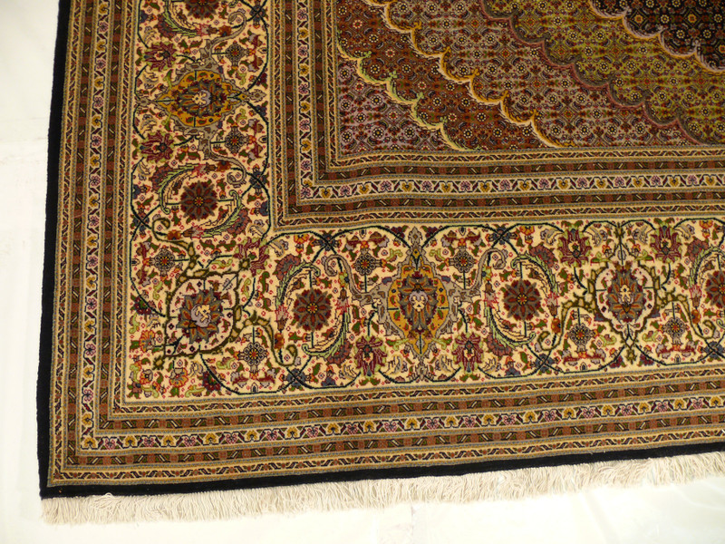 Indulge in the luxurious texture of our Persian Tabriz Rug, handcrafted with the finest wool and silk materials in a 10x10 size that is perfect for any large room