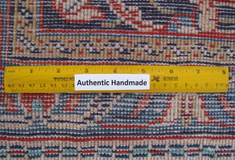 Close-up view of the meticulous hand-tied knots on the back of the luxurious 10x13 Persian Sarough rug