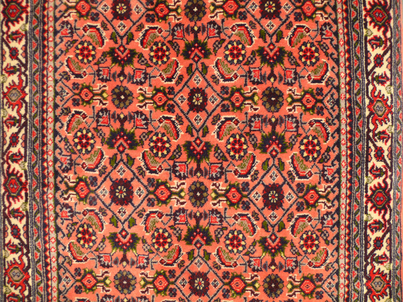 Perspective shot of the Persian Bijar Runner Rug displaying its length and detailed border design.