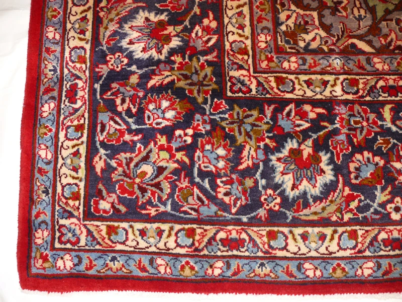 Border Elegance - Persian Isfahan Rug Border: Admire the detailed border of this 9'8 x 13'7 Persian Isfahan rug, a testament to the rug maker's dedication to perfection