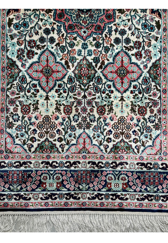 Detailed view of the lower border of a 3 x 5 Persian Qum Silk Rug, showing the intricate floral and geometric motifs.