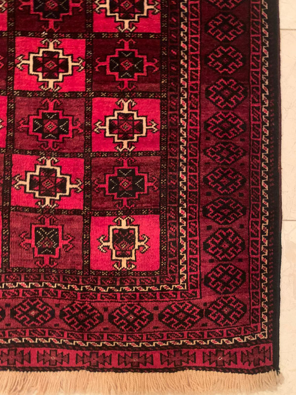 Elegant traditional motifs on the 3'5 x 5'6 Persian Baluch rug in rich colors