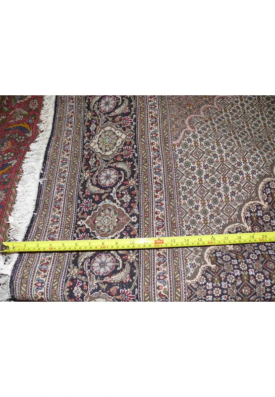 Back of the Persian Tabriz Mahi Rug with a ruler, illustrating the high knot density.