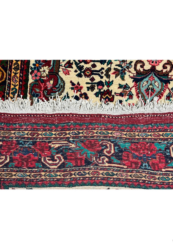 Side detail showing the dense weave and fringe of a vintage Persian Bijar rug."