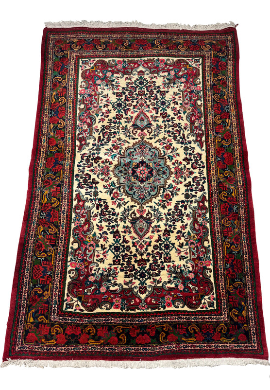Full display of a vintage Persian Bijar rug with floral motifs and rich red and blue color