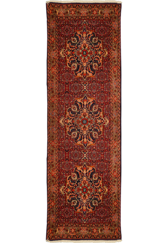 Full-length view of a 3 x 10 Persian Bijar Runner with intricate red, blue, and cream patterns