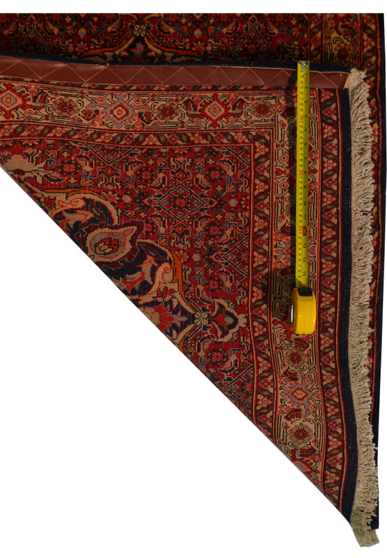 full horizontal view of the Persian Bijar Runner, displaying the symmetry and color consistency across the design.