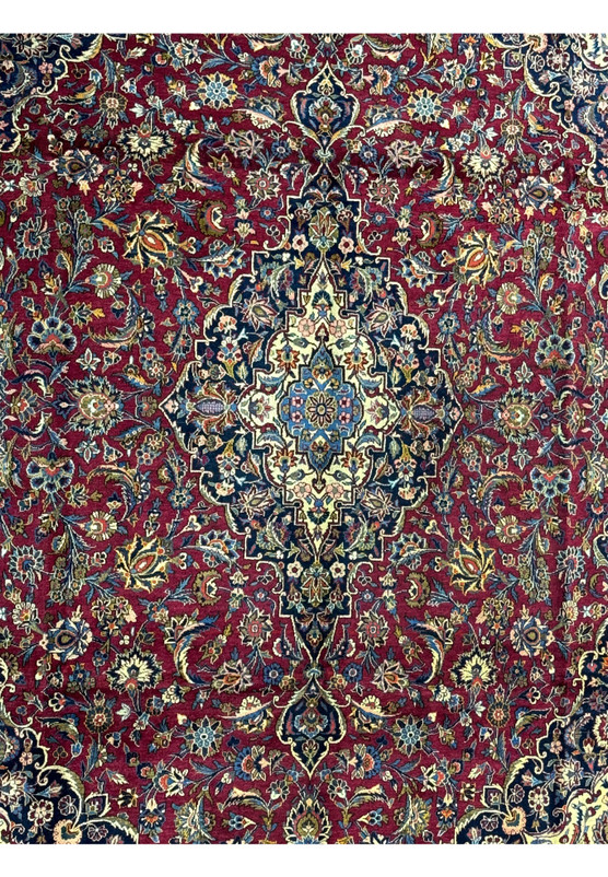 Close-up of the central medallion of a Persian Kashan rug, highlighting the complex designs and vibrant color palette
