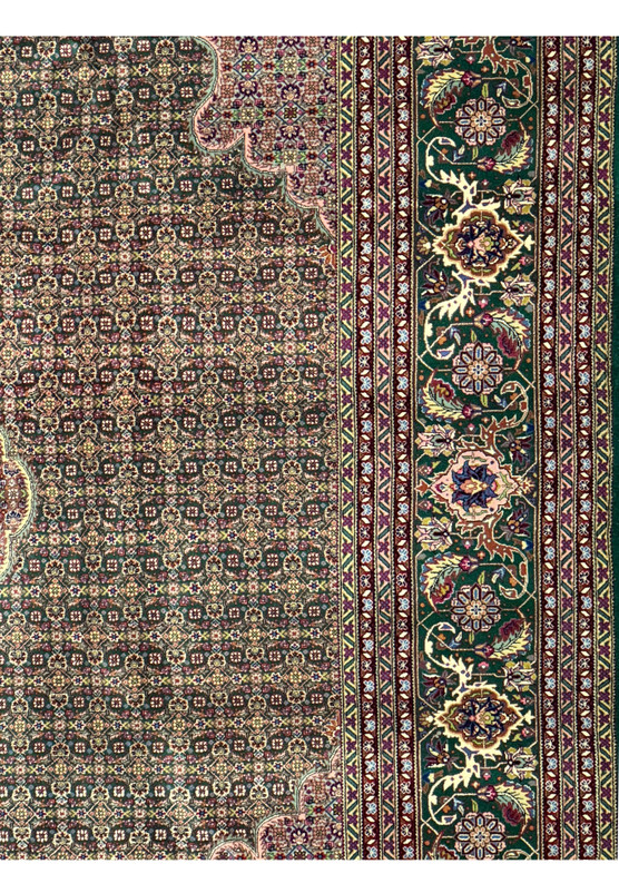 Detailed floral patterns and fish motifs on a Persian Tabriz 50 Raj rug.