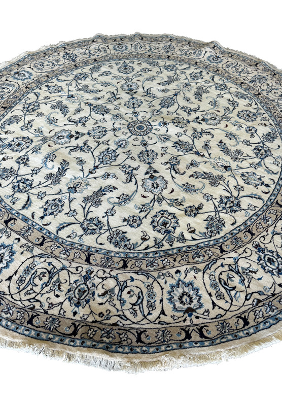 Full view of a round Persian Nain rug showcasing detailed border patterns