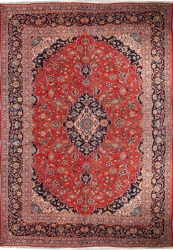 A front-facing image of a Persian Kashan rug laid flat, showing the entire pattern with a vibrant red field, central medallion, and intricate floral and geometric patterns in shades of blue, cream, and orange.