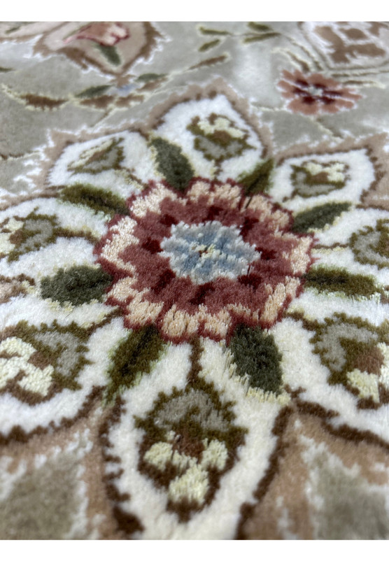 Colorful detail shot of a 12'5" x 18' Persian Tabriz Rug, showcasing a variety of hues and the precision of its floral patterns.