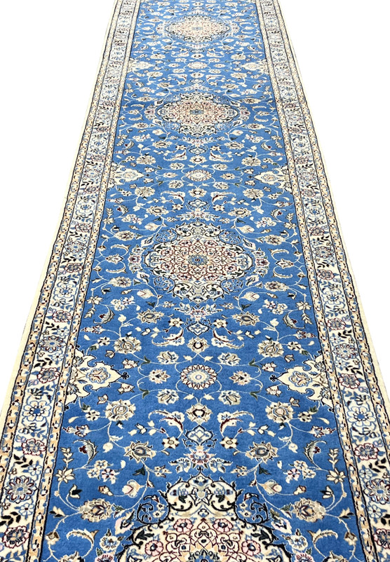Low angle of Persian Nain 6LA Runner revealing shimmering silk details and medallion depth