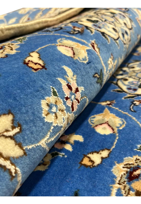 Folded Persian Nain 6LA Runner showing fine wool pile and floral motifs with silk accenting