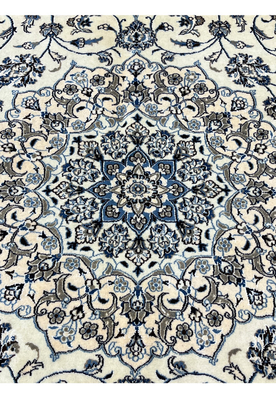 Close-up of 10' x 13'2 Persian Nain 9LA Rug medallion revealing fine silk outlines and detailed hand-knotted floral patterns.