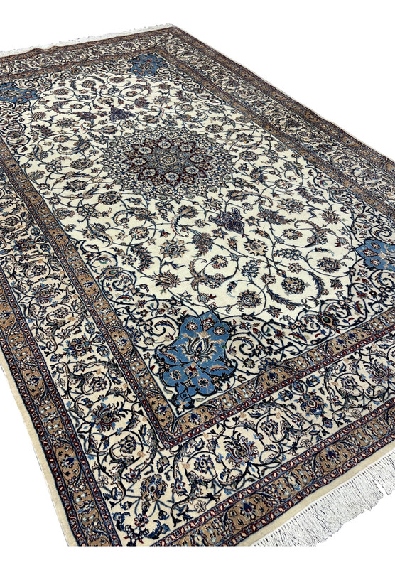 Angled full-view photo of signed Persian Nain 4 LA Habibian rug, highlighting hand-knotted wool and silk texture and finely balanced color palette.