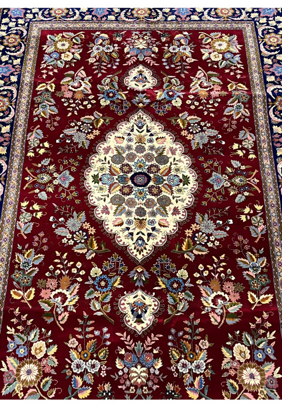 Midfield detail of Persian Isfahan rug highlighting ivory medallion and silk floral accents