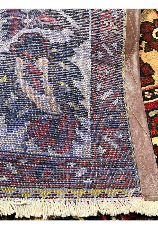 Backside view of a Persian Bakhtiar rug showing tight knotting, consistent weave, clear garden panel layout, and strong wool foundation