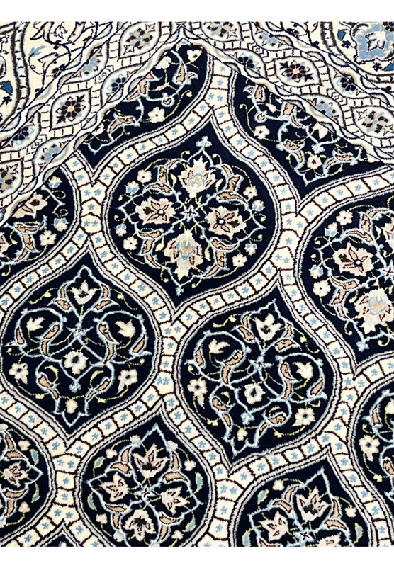 Detailed Gombadi dome pattern on Persian Nain Habibian rug featuring navy cartouches ivory lattice and silk highlights.