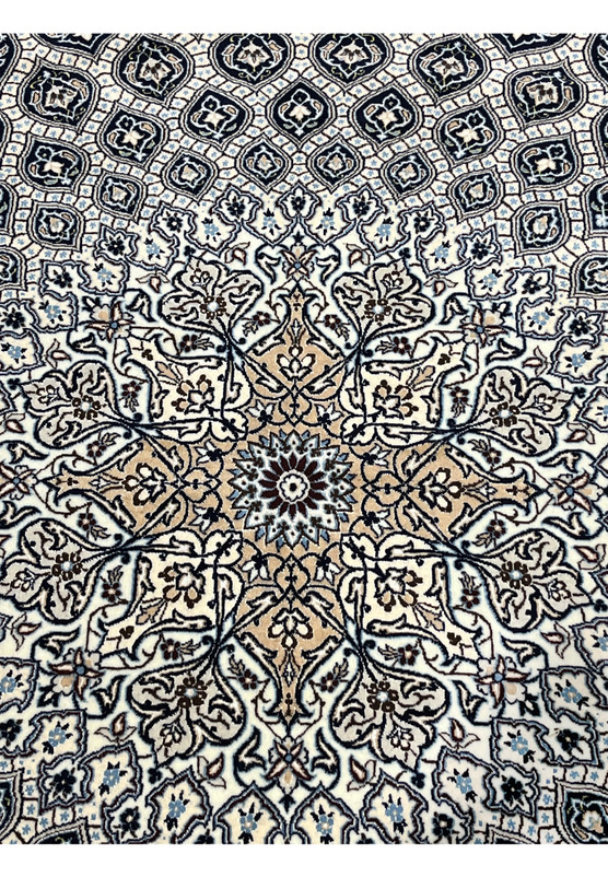 Closeup of central medallion on Persian Nain Habibian 6 LA rug with camel center navy outlines and silk detailed floral rosette.