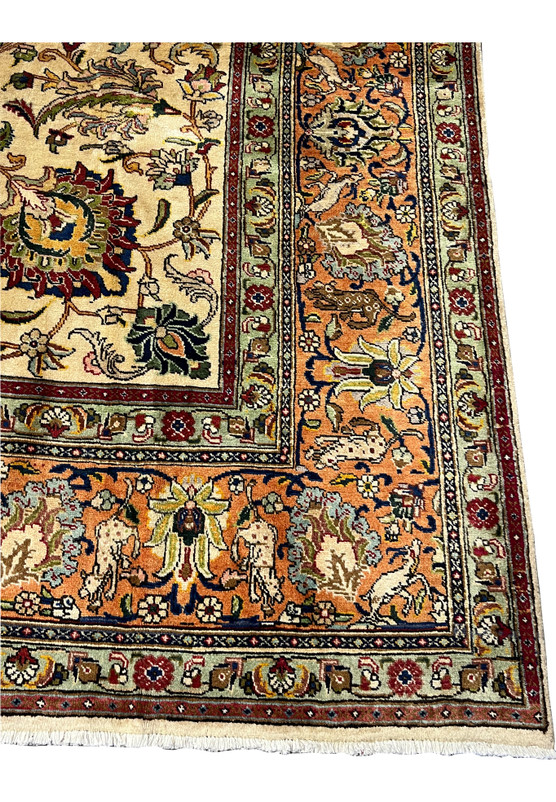 Corner closeup highlighting the terracotta border populated with hunting motifs birds and curling floral scrollwork