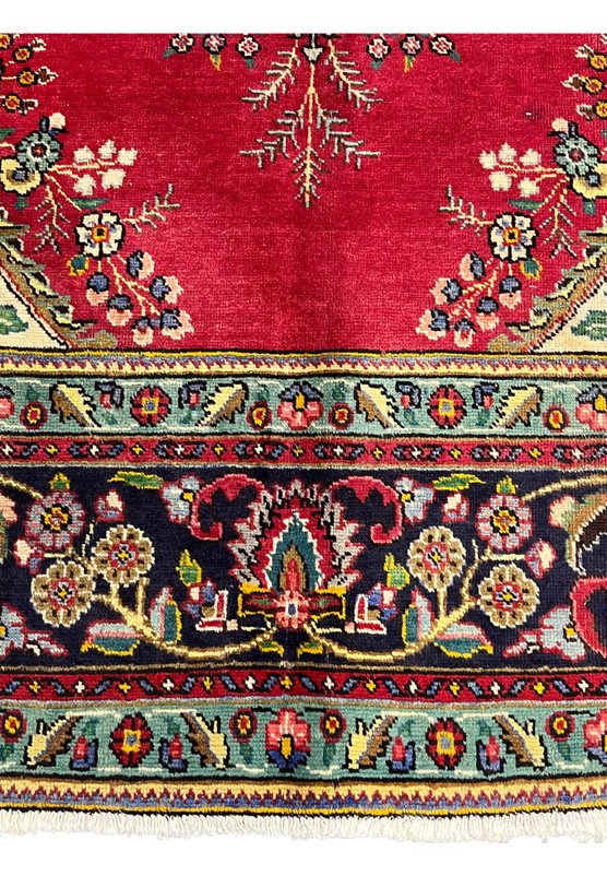 Lower section of 9x13 Persian Kerman rug showing lower pendant cartouche, turquoise minor border, and palmette main border in detail