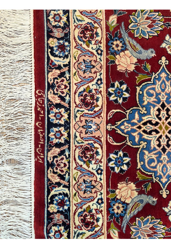 Close up of woven Persian signature reading Iran Esfahan Ahmad Zojaji in Farsi script on the lower border