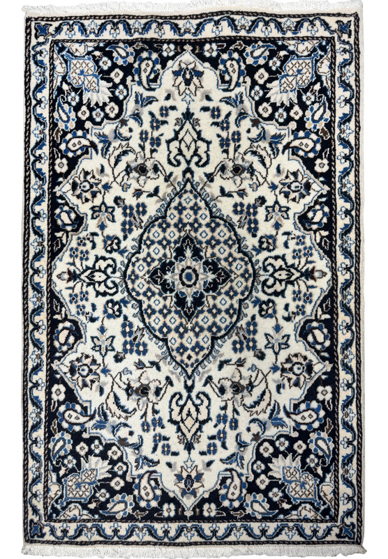 Full overhead view of 3x5 Persian Nain rug, ivory field with navy border and central floral medallion