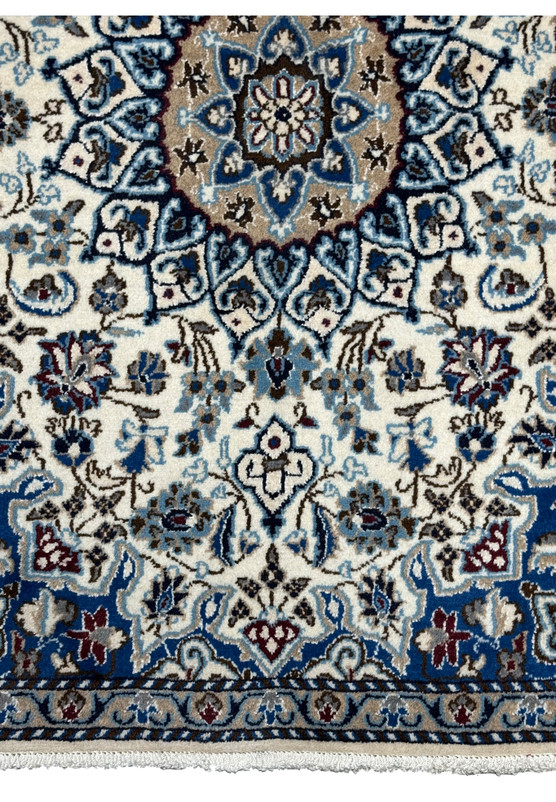 Lower border detail of handmade Nain rug, ivory ground with vine, rosette, and palmette procession