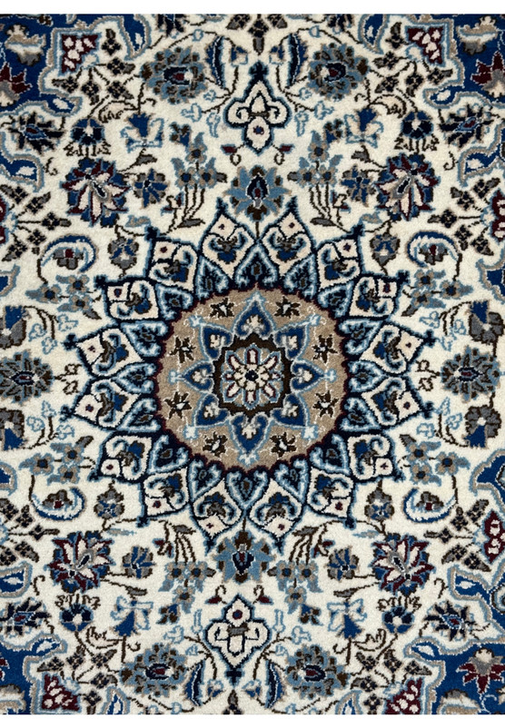 Camel center medallion close-up of authentic Persian Nain rug, sky blue and navy stepped cartouches on ivory ground