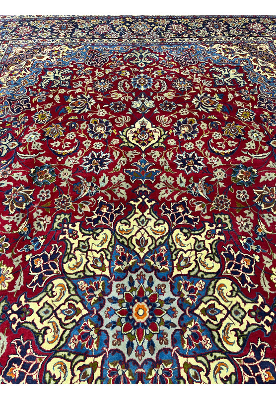 Upper section of the Najafabad rug showing the symmetrical floral field, sized for a large living room