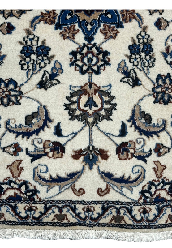 Ivory field of palmettes and vines meeting the border, ideal as an entryway accent rug
