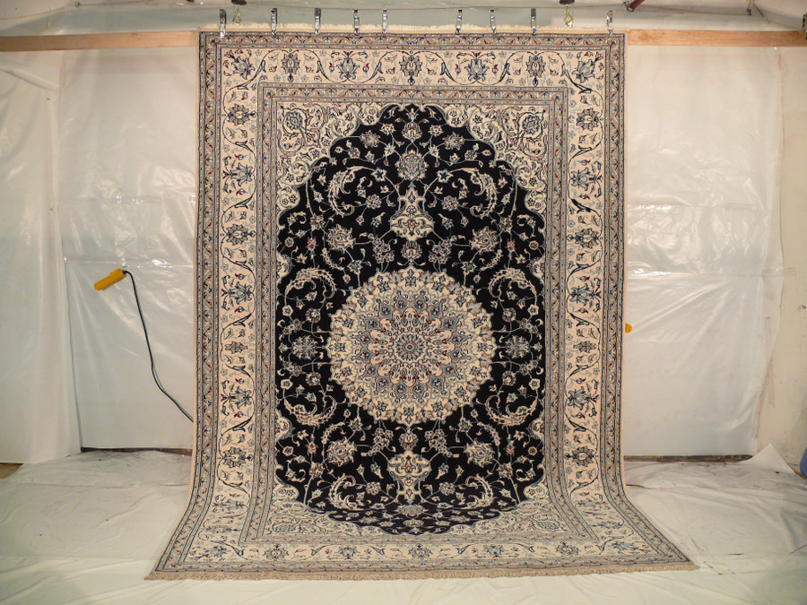 This stunning Persian Nain Rug, made from wool and silk, measures 8'1" x 11'8". The picture shows the entire rug, highlighting its intricate design and exquisite craftsmanship.