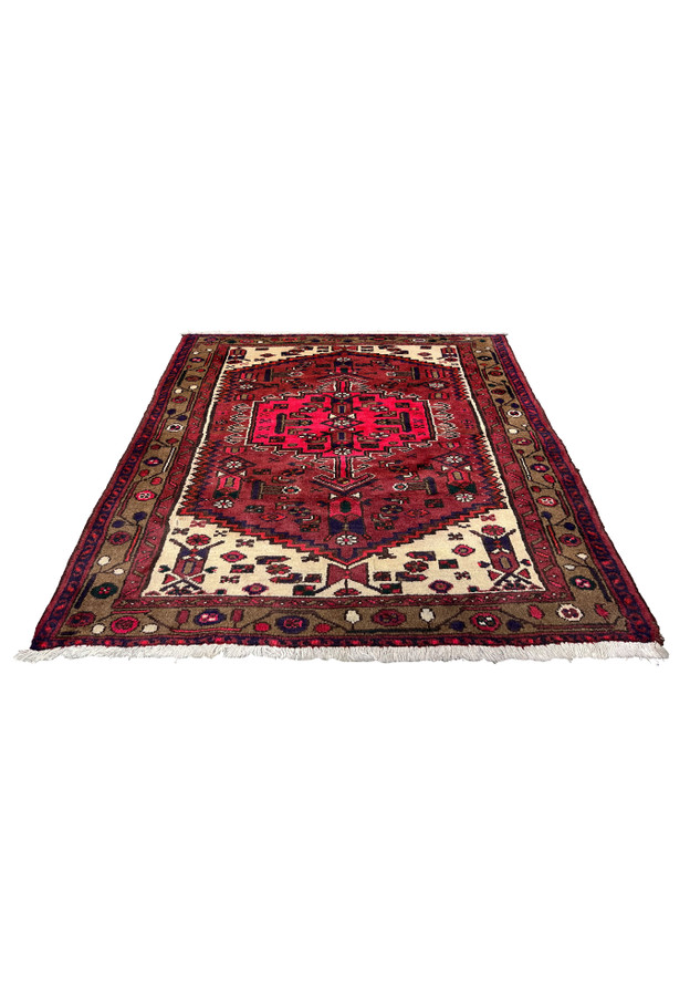 Antique Persian Hamedan tribal rug laid flat, showcasing a strong red field, stepped central medallion, tribal symbols, and balanced ivory corner detailing