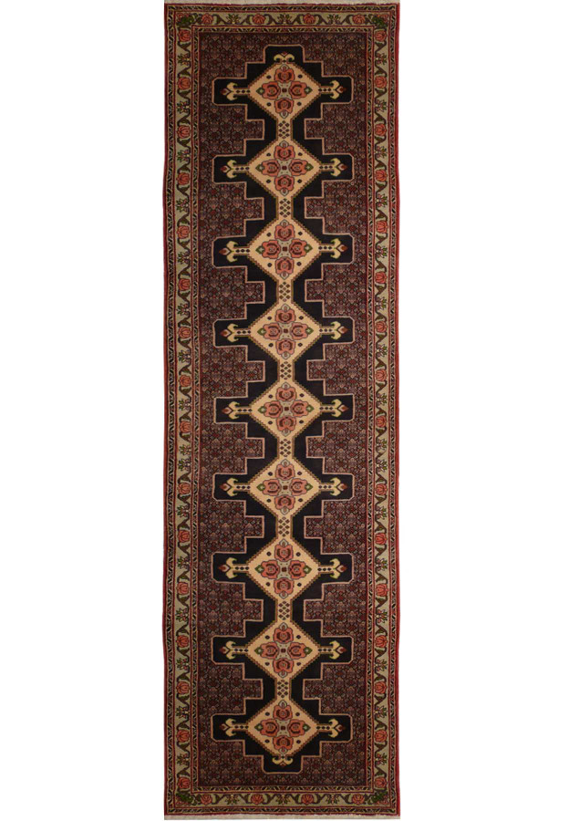 A close-up of a Persian Senneh runner featuring a geometric pattern in shades of blue, red, and ivory.