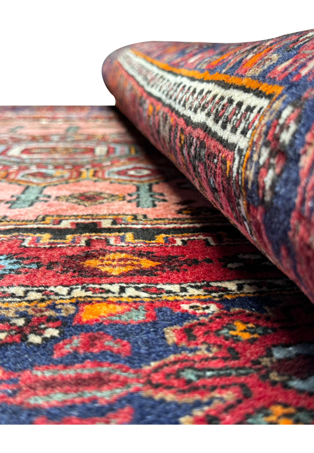 Folded 4x6 Persian Gholtogh rug showcasing the plush pile and pattern continuity.