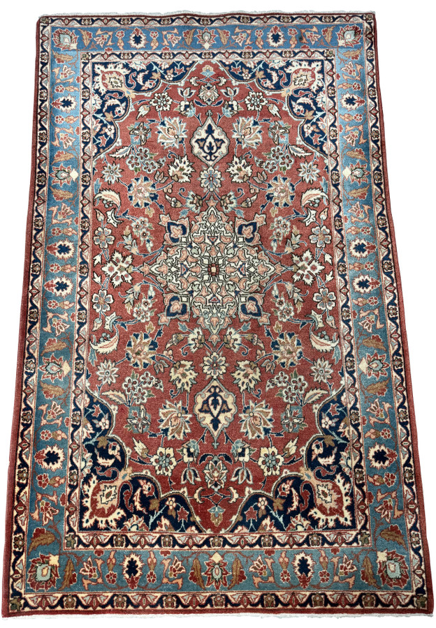 Angled perspective of a 3x5 Antique Mashad Rug, emphasizing the depth of color and traditional design elements.