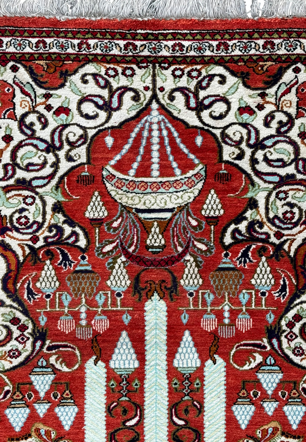 Persian Qum silk rug corner displaying the fine craftsmanship and detailed border patterns