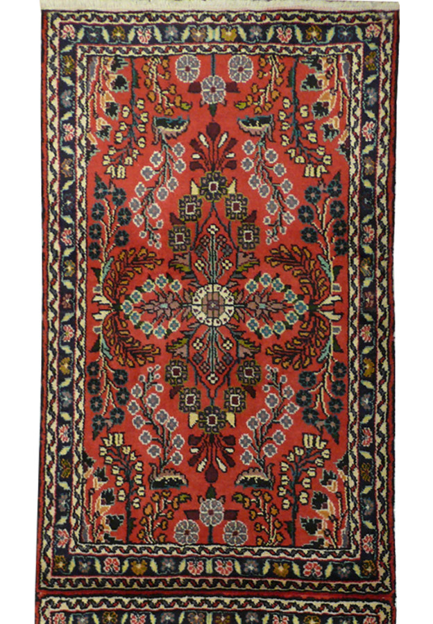 A detailed view of a Persian Darjazin runner rug showing the intricate floral and geometric patterns in deep red, black, and cream colors
