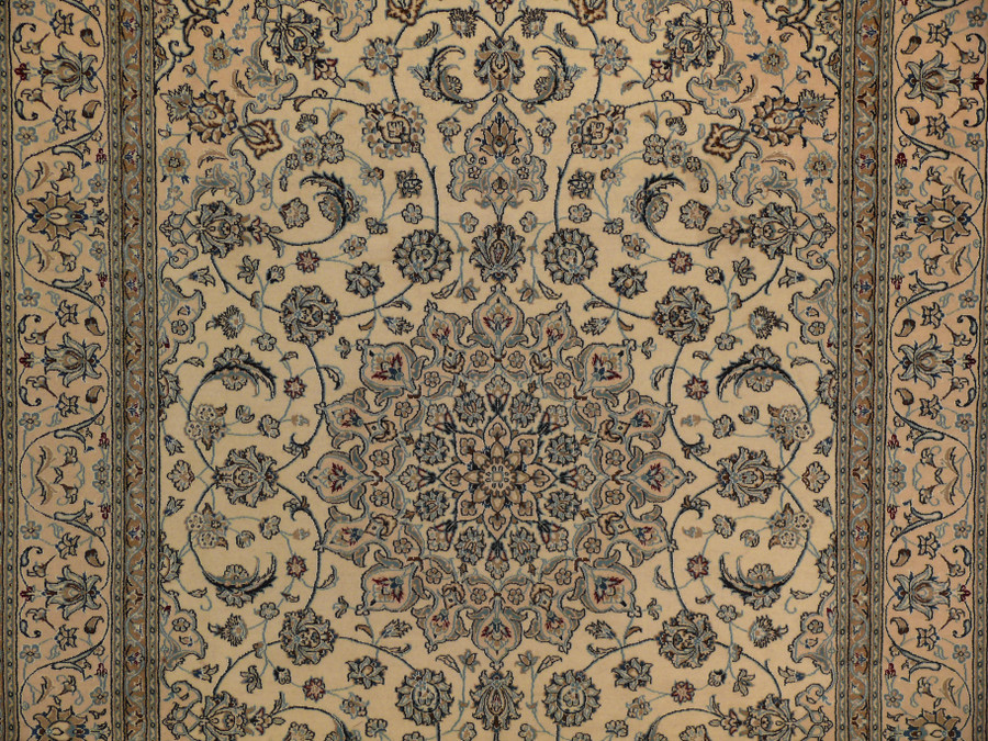 Close-up of central medallion with navy background, wine red blossoms, and ivory outlines