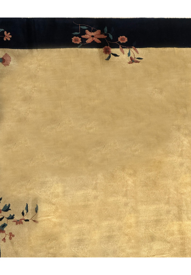 Magnified view of the corner detailing on a Vintage Art Deco Rug, highlighting the navy blue border and beige center with delicate floral art