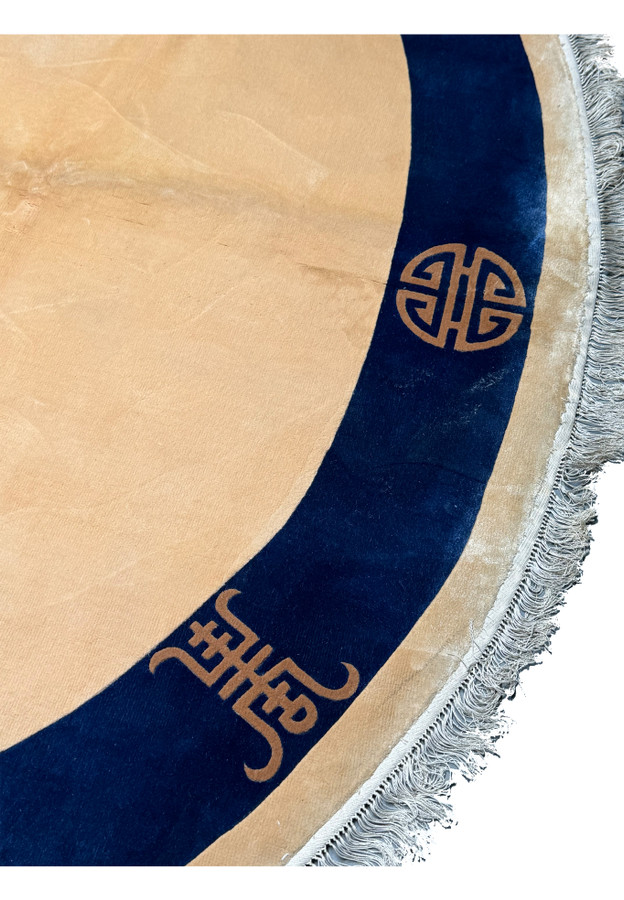 Detailed craftsmanship of traditional Asian symbols on the border of a 4x6 oval Art Deco silk rug