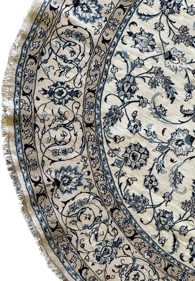 Detailed floral design of a 9'8 x 9'8 Persian Nain round rug