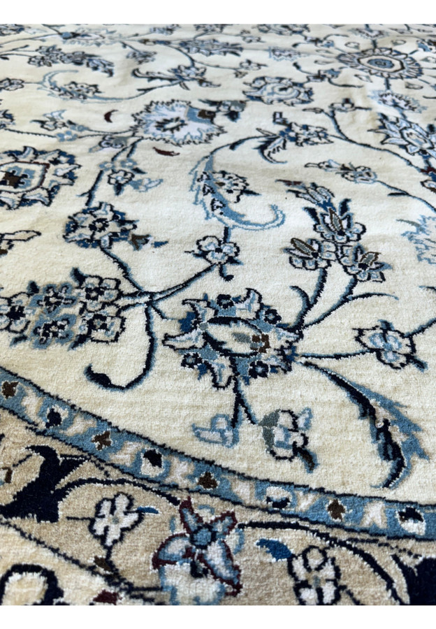 Overhead view of a 9'8 x 9'8 Persian Nain Round Rug with cream base and blue floral patterns