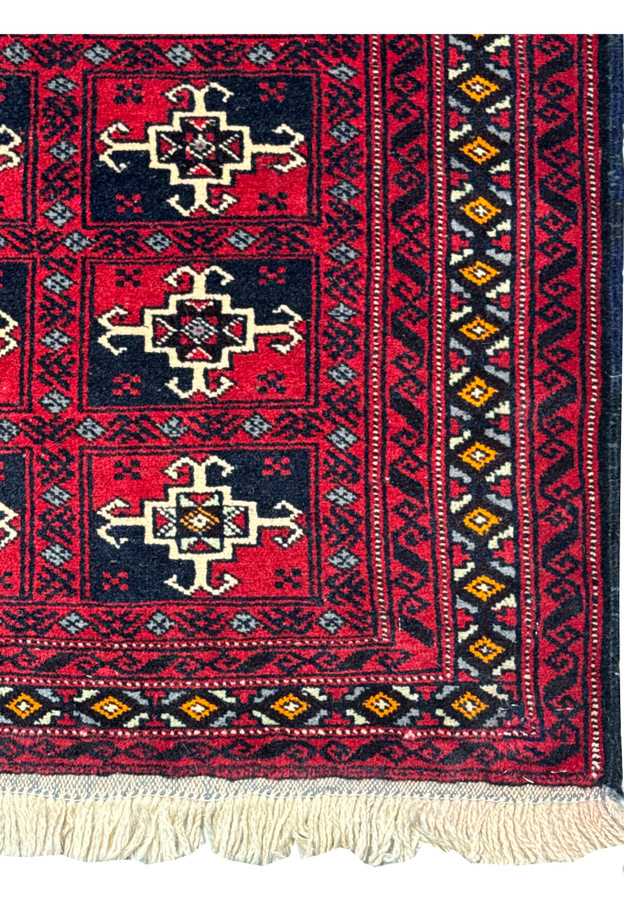 Close-up of the central part of the rug, focusing on the geometric patterns and the color contrast.