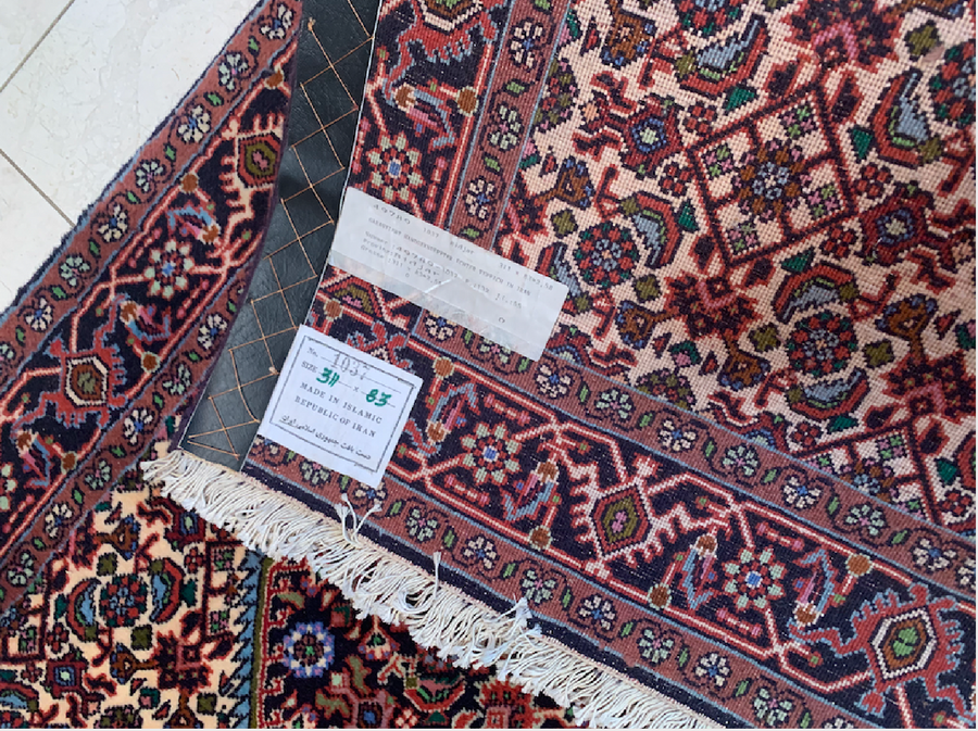 The back of a persian bidjar runner showing the label the fine and dense knots of this timeless 2'9 x 10'2 Persian Bijar rug